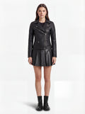 Female model wearing Maverick Scarlett leather biker jacket, slim fit, styled with Maverick Poppy black pleated leather skirt. Maverick Jacket.