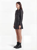 Side profile of Maverick Scarlett biker jacket showing zippered sleeve cuffs and cropped waist silhouette. Maverick Jacket.