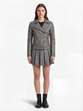 Female model wearing Maverick Morrigan leather biker jacket, slim fit, styled with Maverick Poppy grey pleated leather skirt. Maverick Jacket.