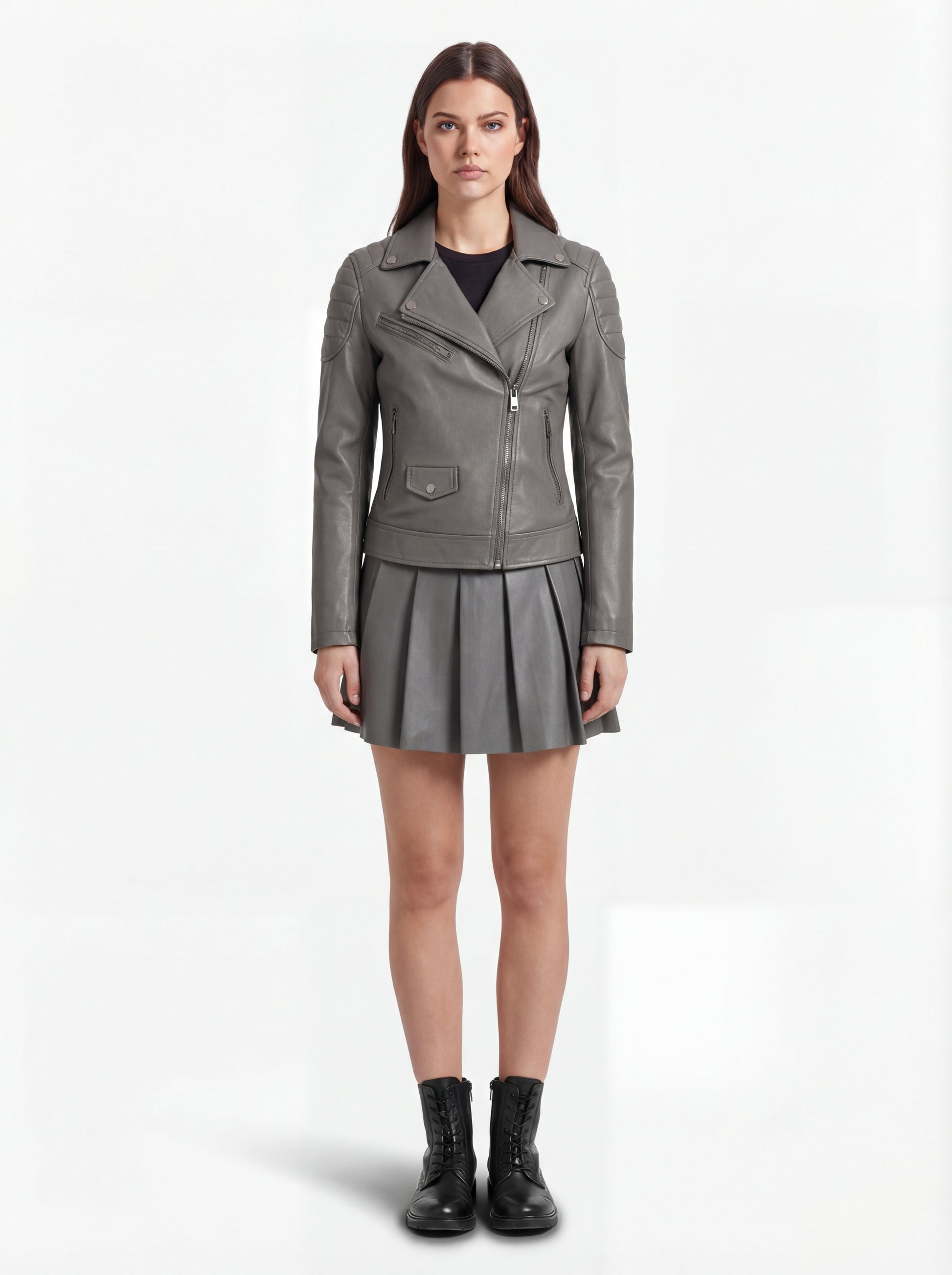 Female model wearing Maverick Morrigan leather biker jacket, slim fit, styled with Maverick Poppy grey pleated leather skirt. Maverick Jacket.