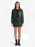 Female model wearing Maverick Isla leather bomber jacket, relaxed fit, styled with Maverick Orla green leather mini skirt. Maverick Jacket.