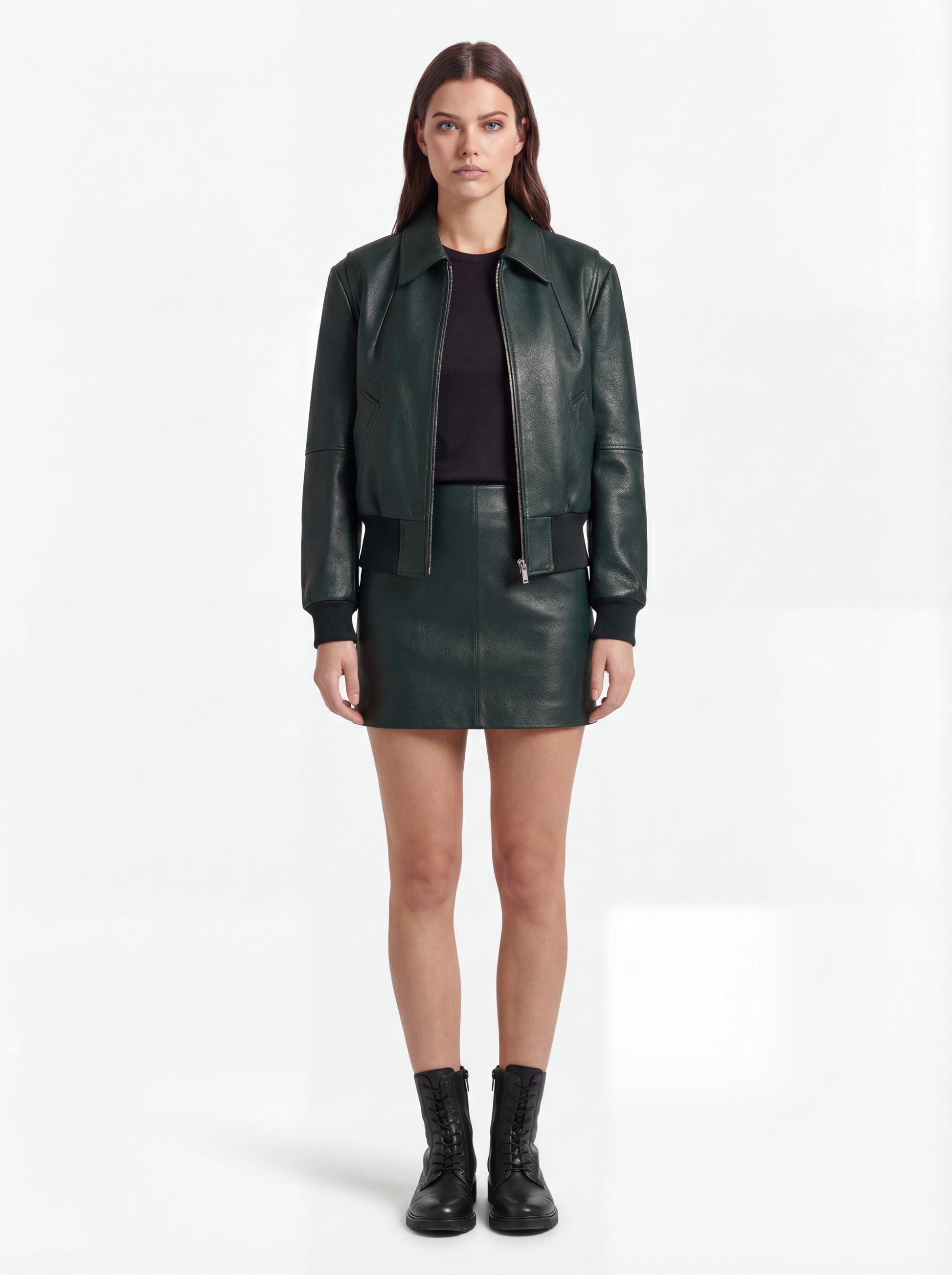 Female model wearing Maverick Isla leather bomber jacket, relaxed fit, styled with Maverick Orla green leather mini skirt. Maverick Jacket.