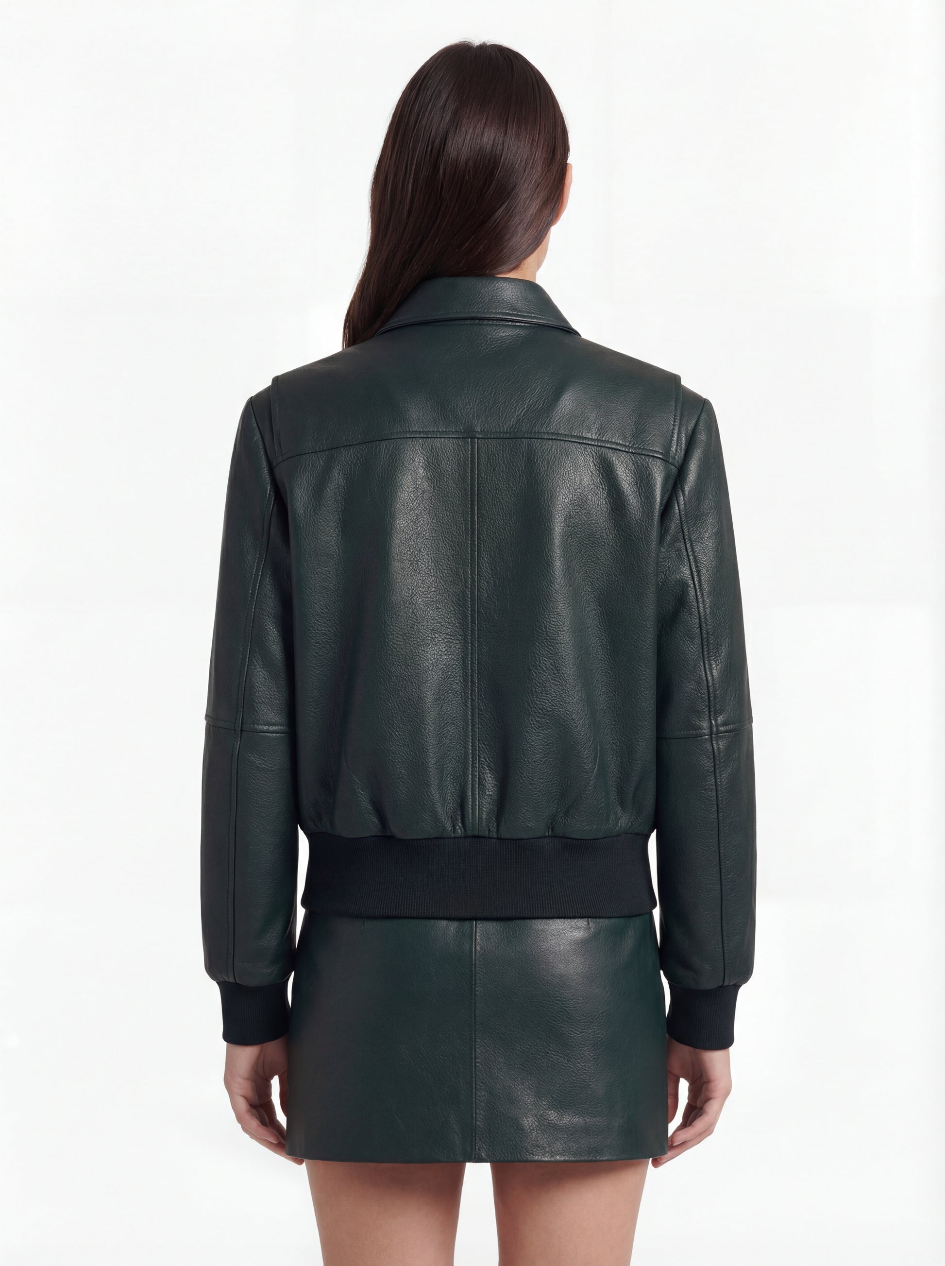 Rear view of female model wearing Maverick Isla leather bomber jacket showing structured shoulder fit and elasticated hem styling. Maverick Jacket.