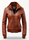 Women's tan leather bomber jacket with ribbed knit standing collar and zippered waist pockets, Front View. The Blair by Maverick Jacket.