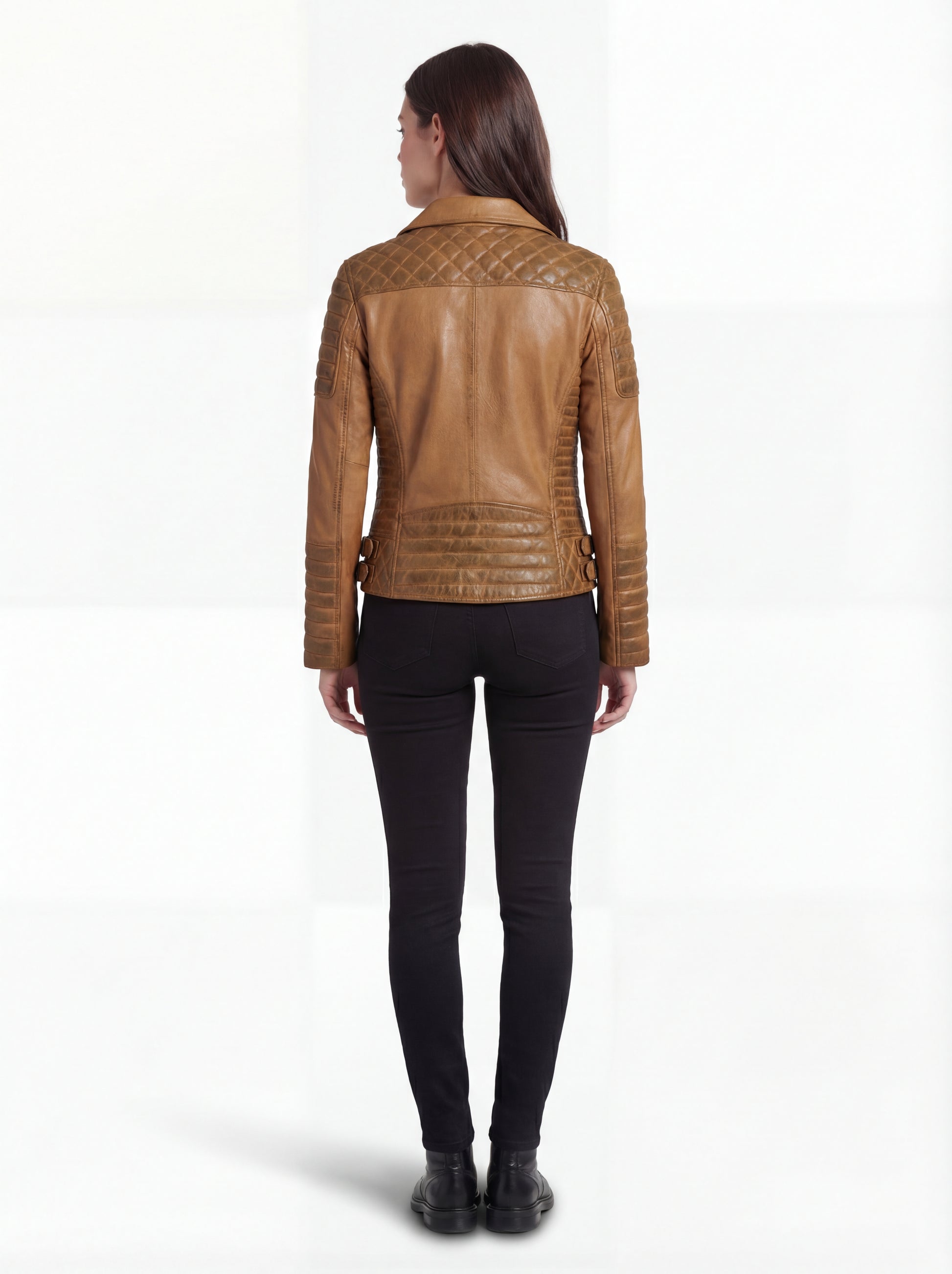 Rear view of female model wearing Maverick Ava leather biker jacket showing structured shoulder fit and diamond quilted back yoke. Maverick Jacket.