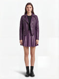 Female model wearing Maverick Iris leather biker jacket, slim fit, styled with Maverick Poppy purple pleated leather skirt. Maverick Jacket.