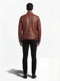 Rear view of male model wearing Maverick Meridian cafe racer jacket showing fitted shoulder silhouette and clean back paneling. Maverick Jacket.