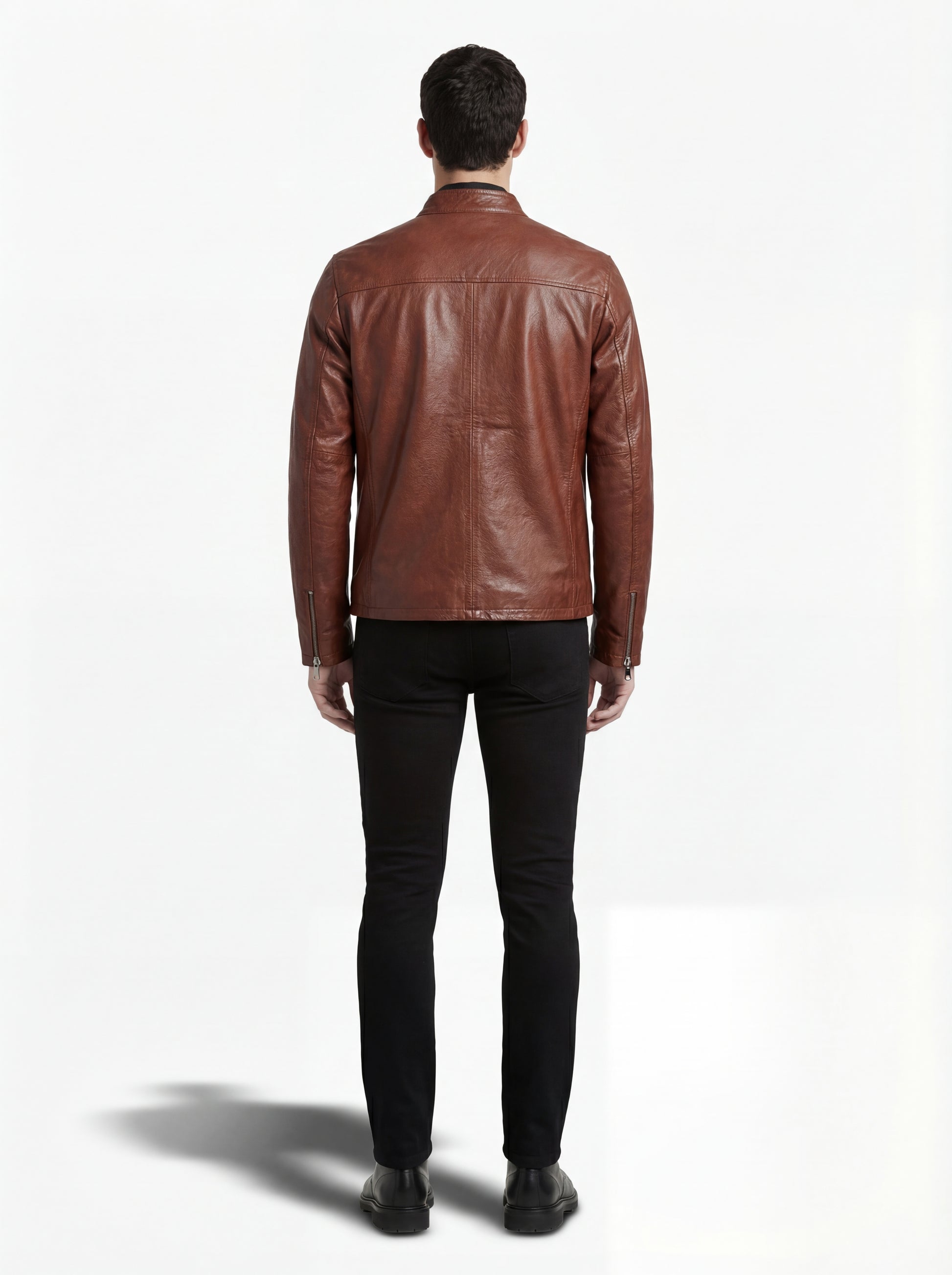 Rear view of male model wearing Maverick Meridian cafe racer jacket showing fitted shoulder silhouette and clean back paneling. Maverick Jacket.