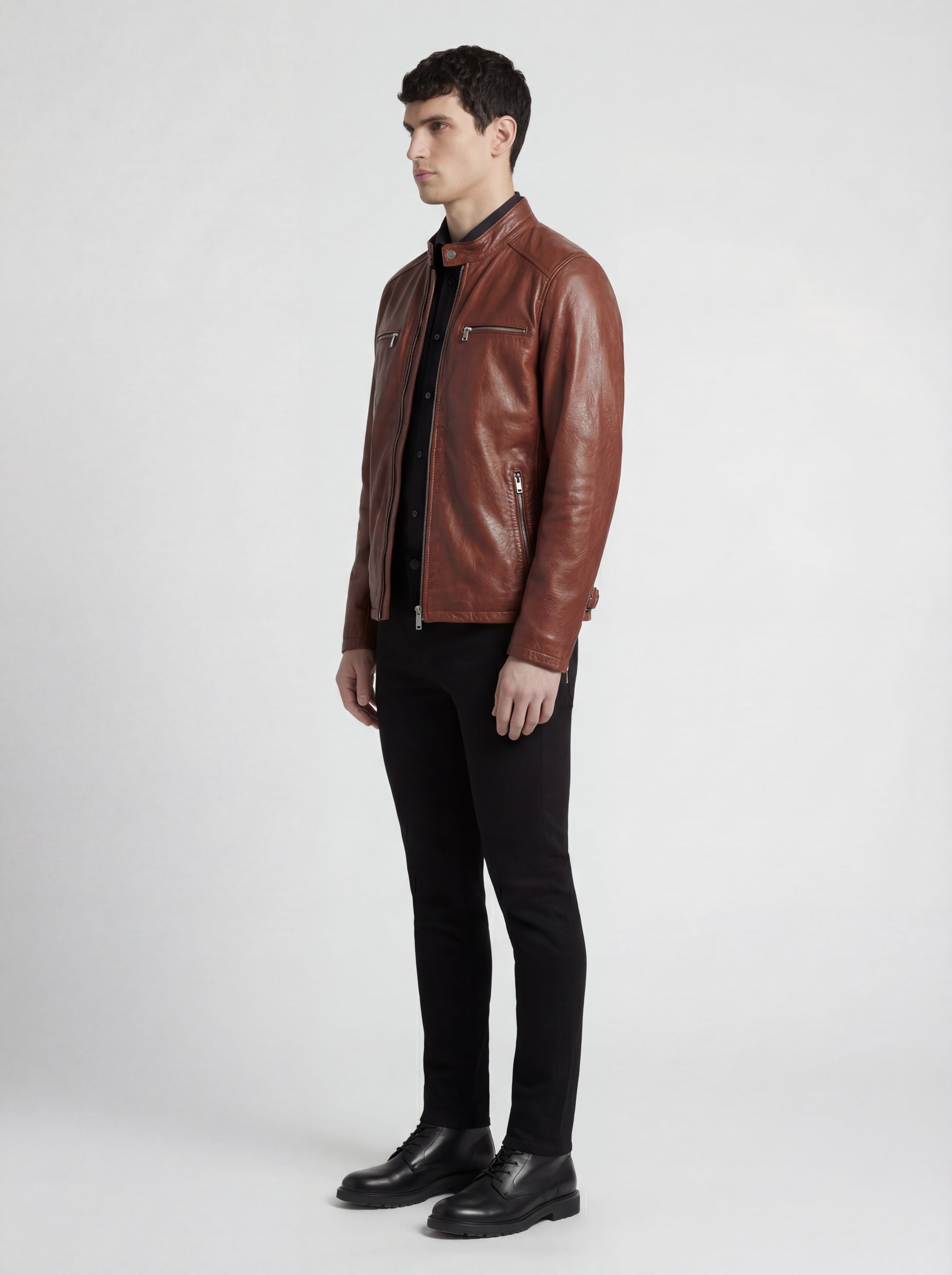 Side profile of Maverick Meridian cafe racer jacket showing zippered sleeve cuffs and streamlined torso fit. Maverick Jacket.