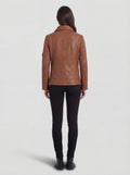 Rear view of female model wearing Maverick Quinn leather utility jacket showing structured shoulder fit and clean back paneling. Maverick Jacket.