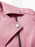 Macro shot of grained pink leather texture and silver snap button lapel detail on biker jacket. The Harlow by Maverick Jacket.