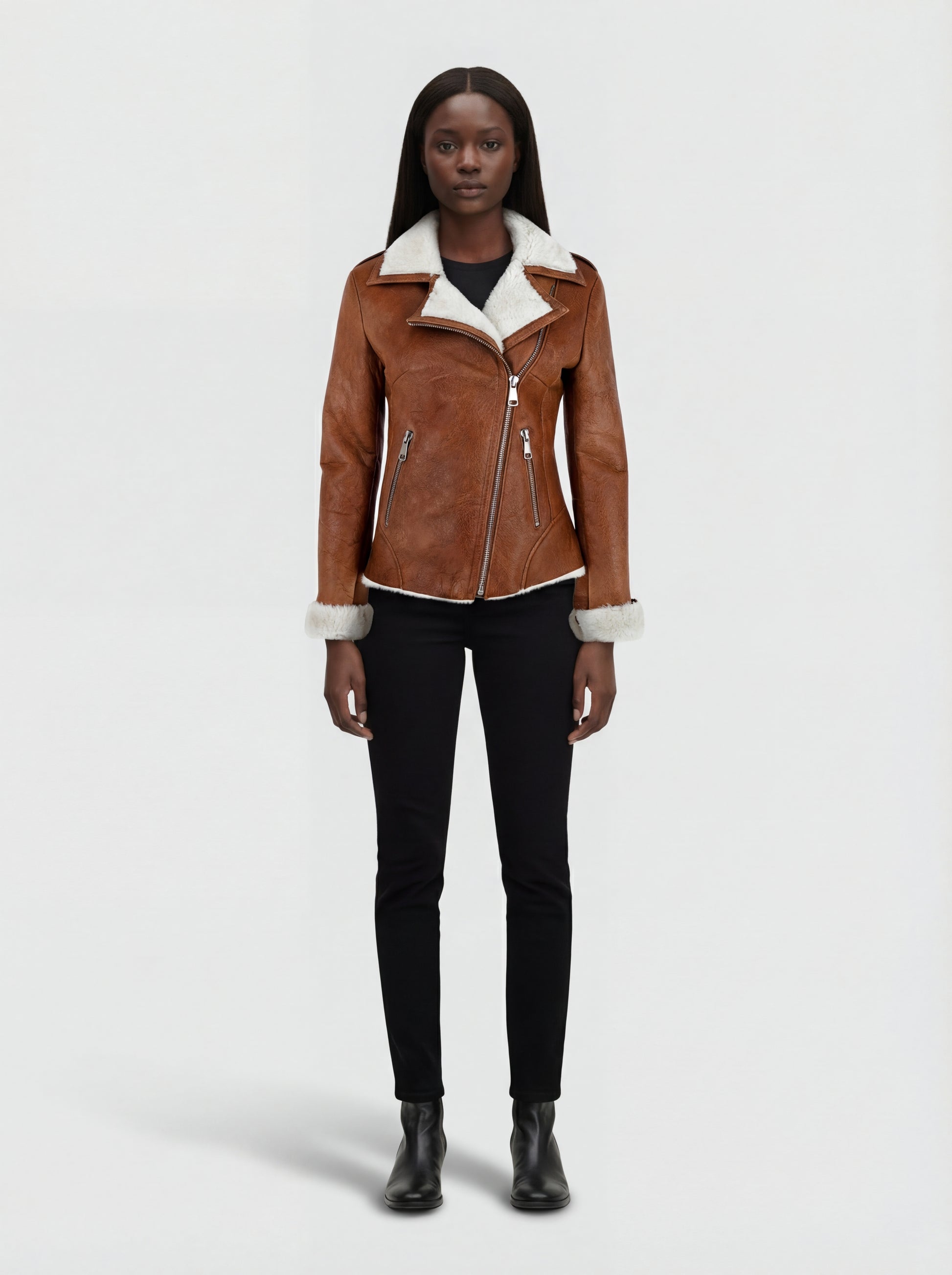 Female model wearing Maverick Astra biker jacket, slim fit, styled with black skinny jeans and leather ankle boots. Maverick Jacket.