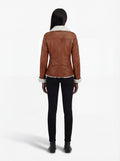 Rear view of female model wearing Maverick Astra biker jacket showing tapered waist fit and shearling hemline. Maverick Jacket.