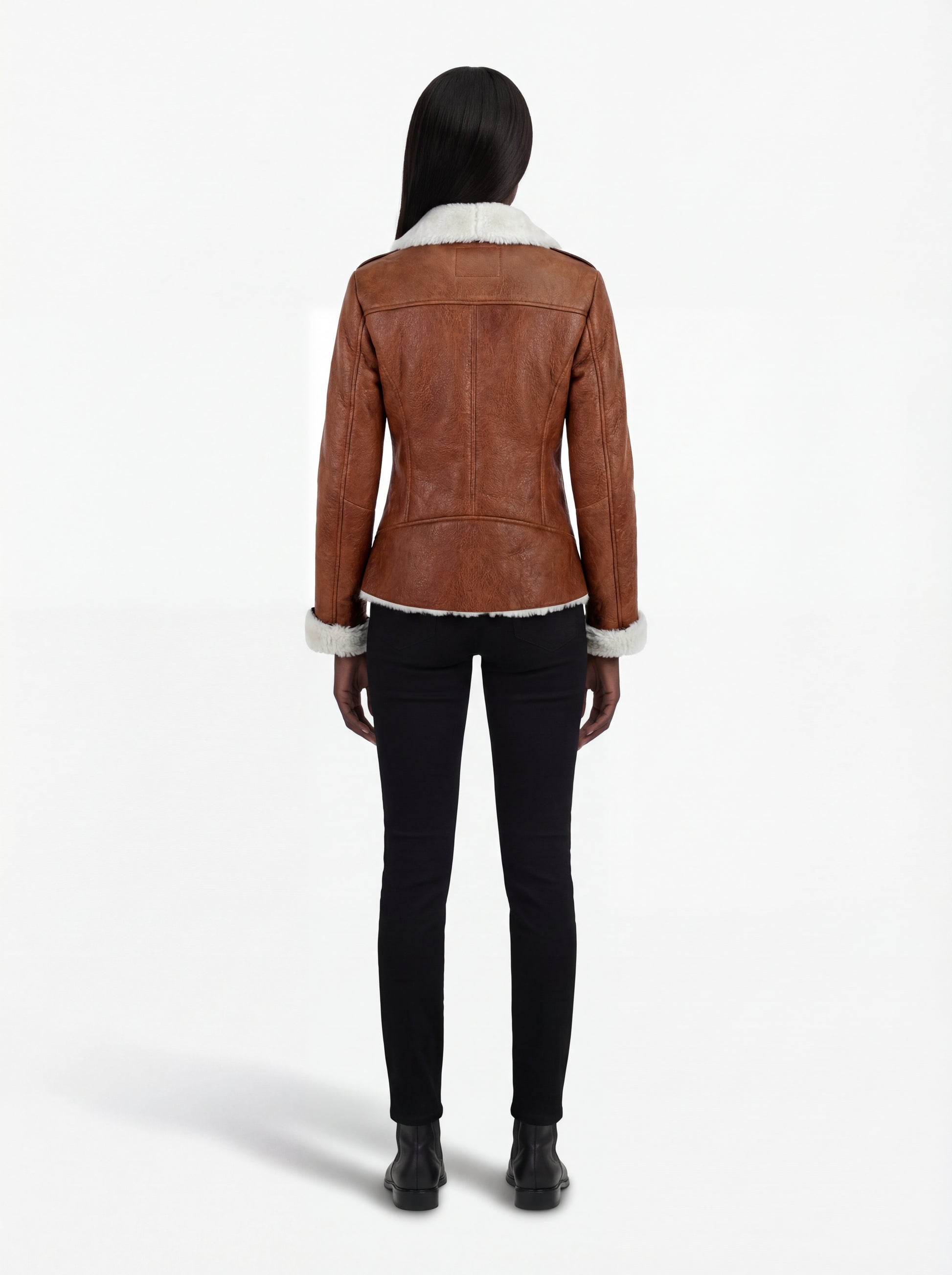 Rear view of female model wearing Maverick Astra biker jacket showing tapered waist fit and shearling hemline. Maverick Jacket.