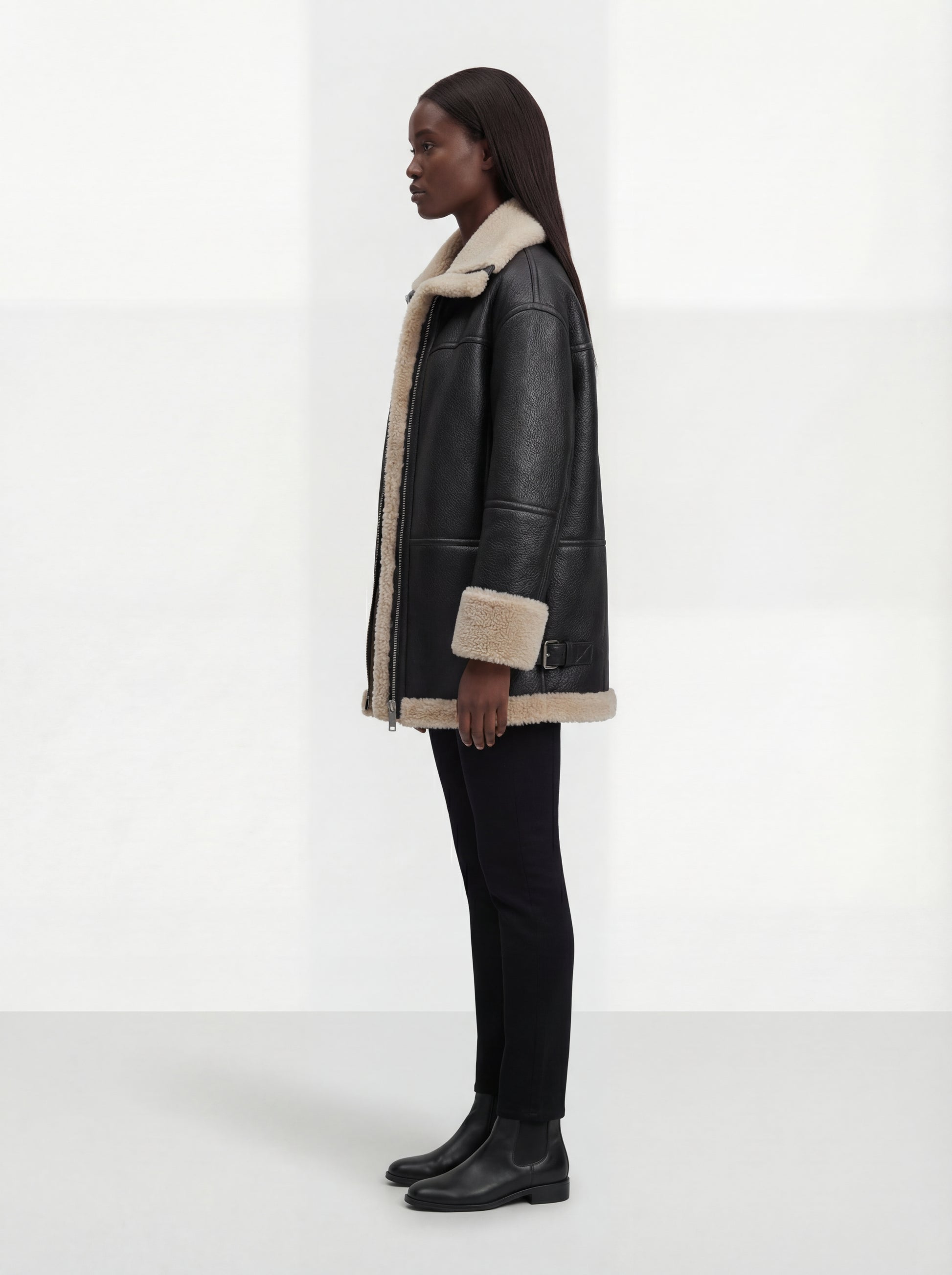 Side profile of Maverick Lyra aviator jacket showing shearling-cuffed sleeves and relaxed silhouette. Maverick Jacket.