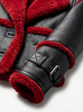 Macro shot of vibrant red shearling wool texture and black pebbled leather grain on biker jacket. The Phoenix by Maverick Jacket.
