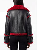 Rear view of female model wearing Maverick Phoenix biker jacket showing structured shoulder fit and red fur hem trim. Maverick Jacket.