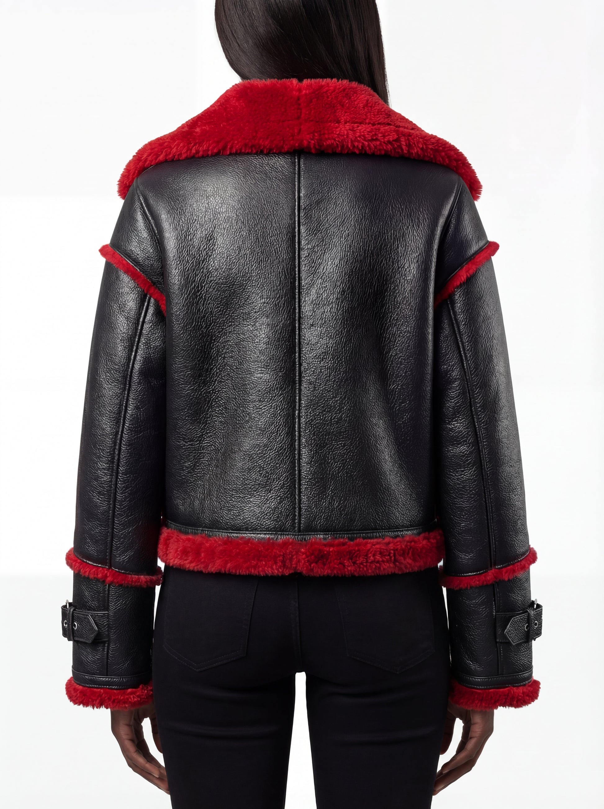 Rear view of female model wearing Maverick Phoenix biker jacket showing structured shoulder fit and red fur hem trim. Maverick Jacket.