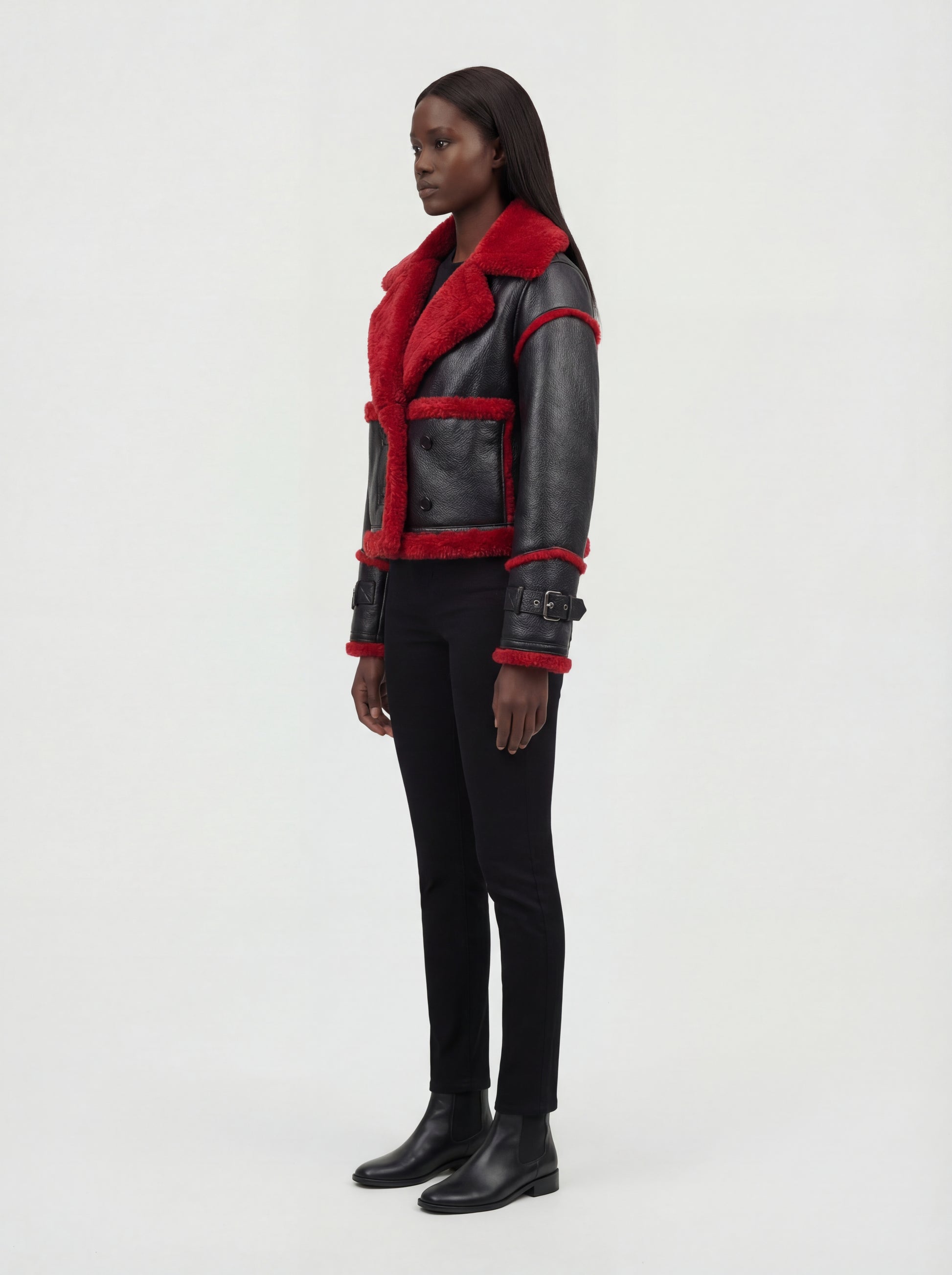 Side profile of Maverick Phoenix biker jacket showing buckled sleeve cuffs and boxy silhouette. Maverick Jacket.