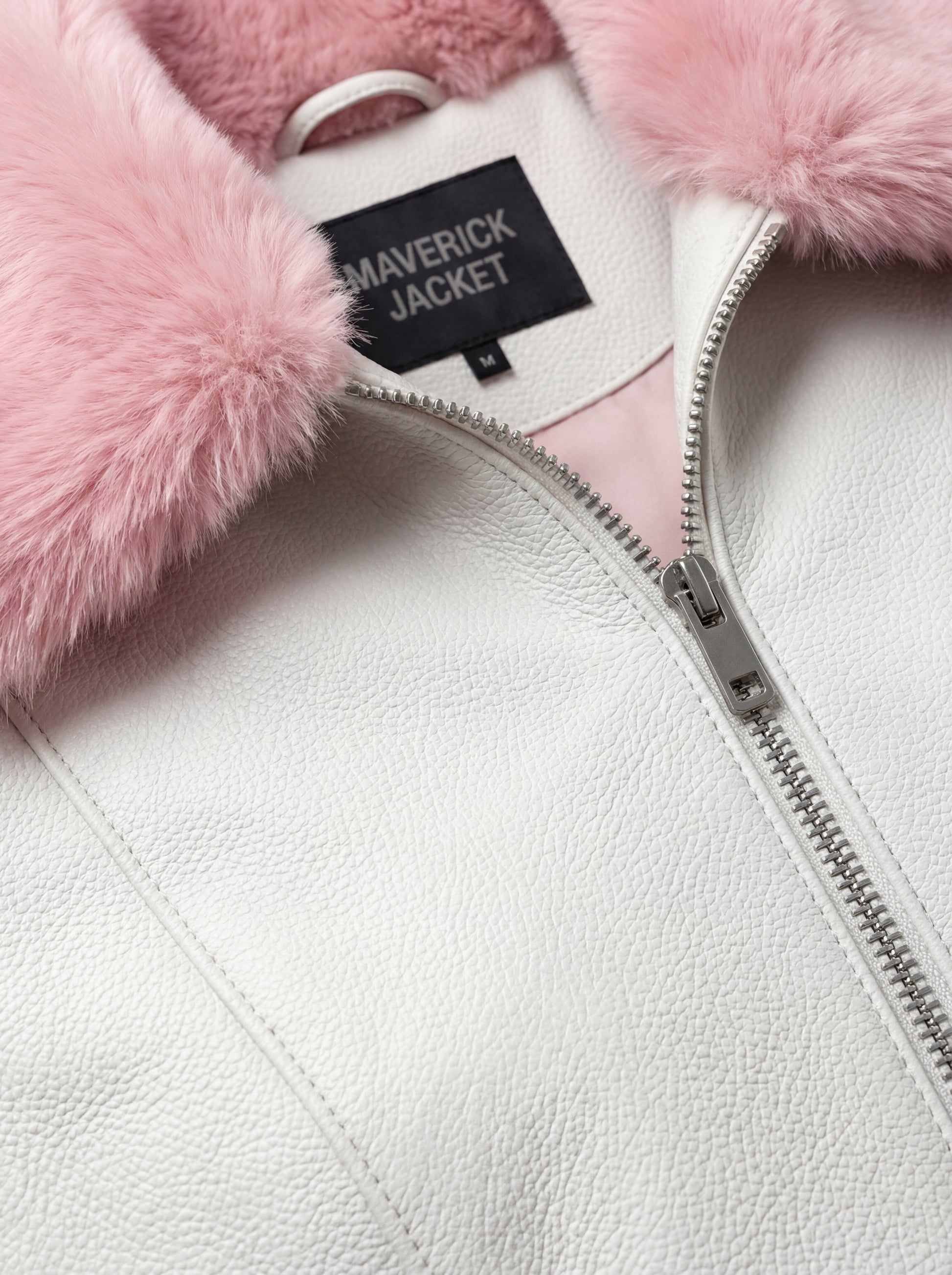 Macro shot of white pebbled leather grain and soft pink shearling texture on collar. The Venus by Maverick Jacket.