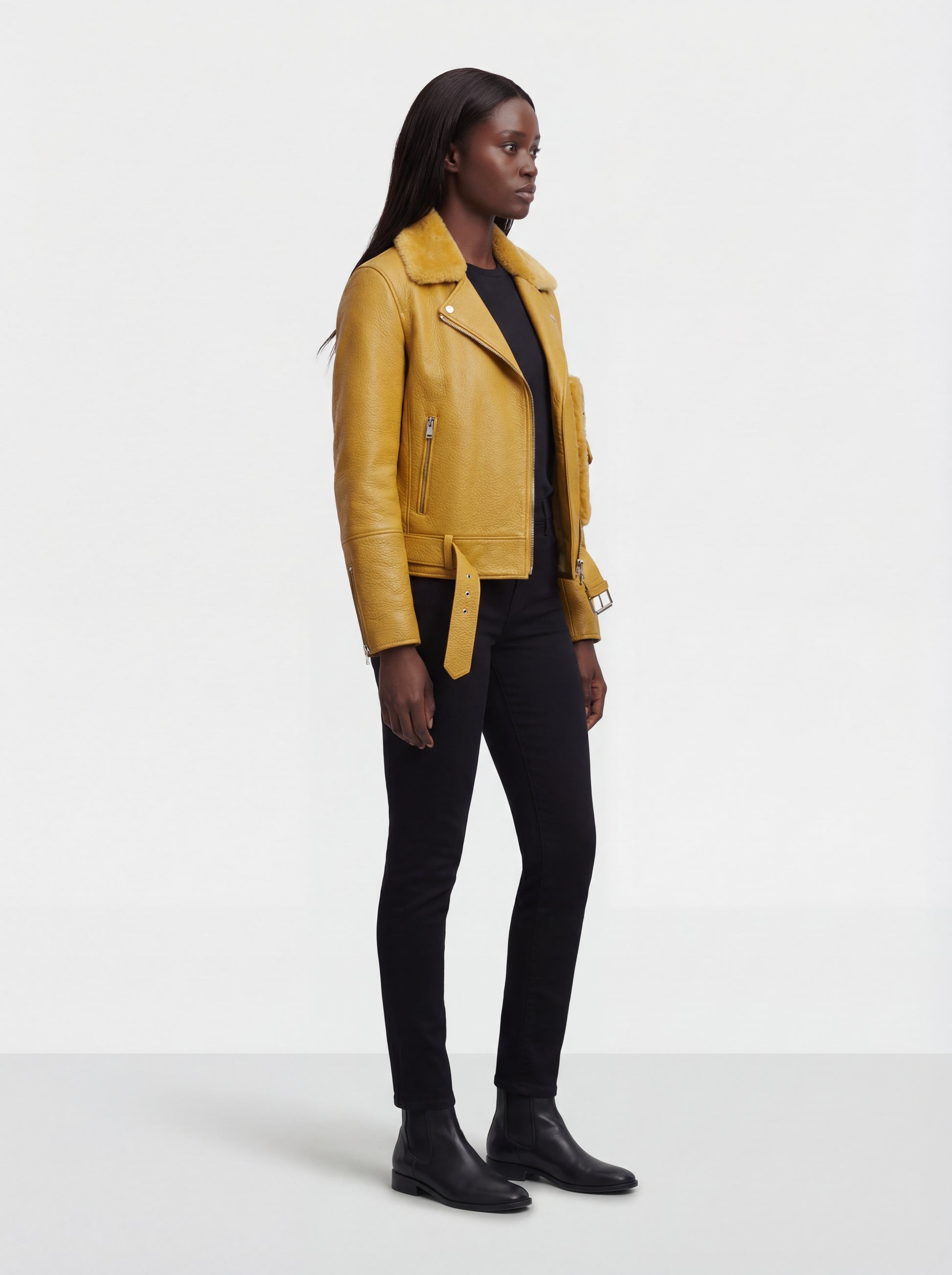 Side profile of Maverick Solar biker jacket showing zippered sleeve cuffs and cropped silhouette. Maverick Jacket.