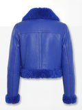 Rear view of blue pebbled leather biker jacket showing vertical center seam and thick blue shearling hem. The Cobalt by Maverick Jacket.