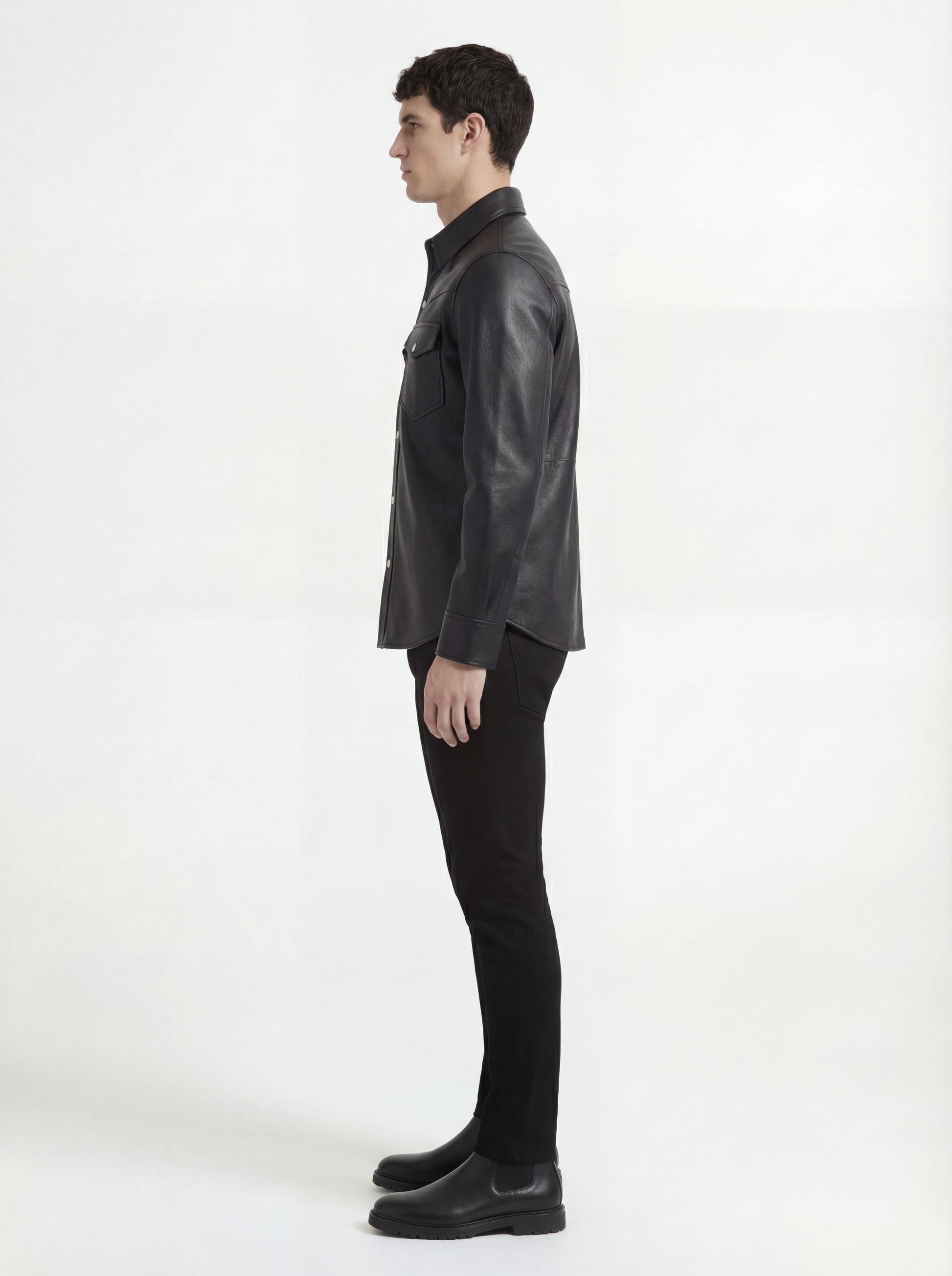 Side profile of Maverick Easton leather western shirt showing long sleeve cuff structure and straight silhouette. Maverick Jacket.