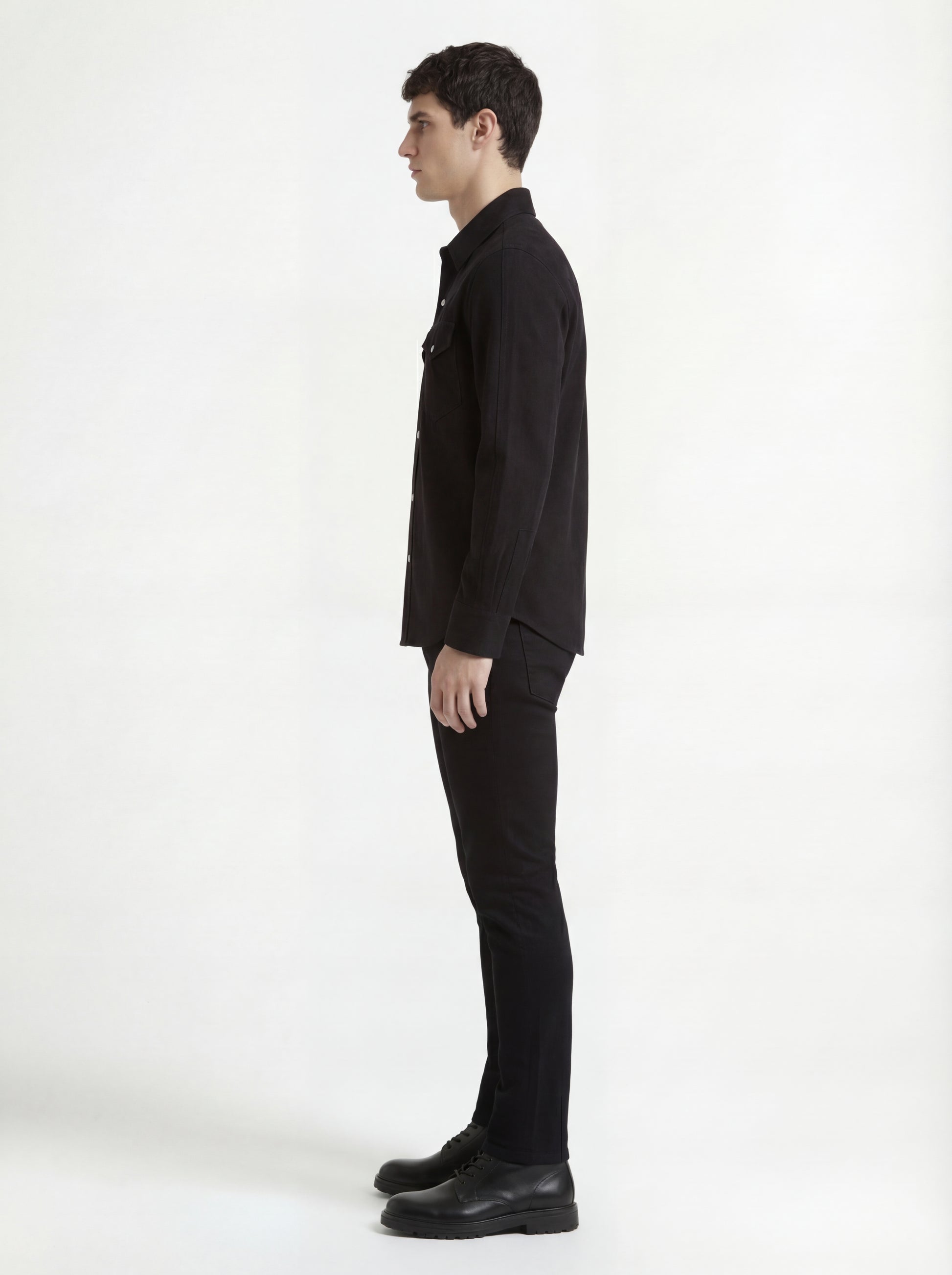 Side profile of Maverick Cole suede western shirt showing long sleeve cuff structure and straight silhouette. Maverick Jacket.