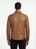 Rear view of male model wearing Maverick Colton tan leather western shirt showing tailored shoulder fit and western yoke styling. Maverick Jacket.
