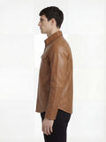 Side profile of Maverick Colton tan leather western shirt showing long sleeve cuff structure and straight silhouette. Maverick Jacket.