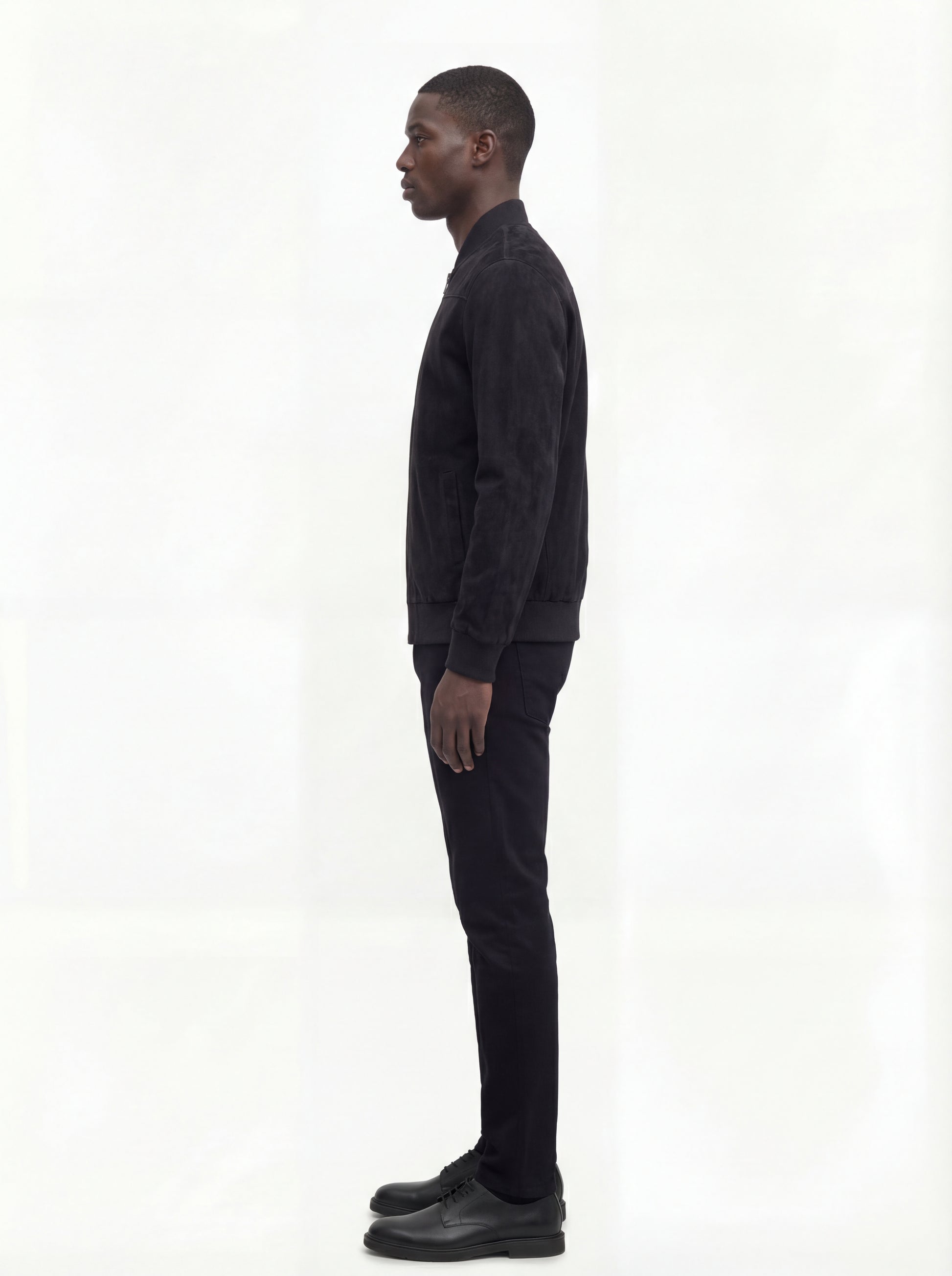 Side profile of Maverick Felix suede bomber jacket showing ribbed sleeve cuffs and classic bomber silhouette. Maverick Jacket.