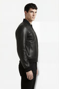 Rear view of male model wearing Maverick Vanta bomber jacket showing structural quilted back yoke and fitted ribbed waistband. Maverick Jacket.