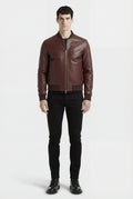 Male model wearing Maverick Ferran leather bomber jacket, regular fit, styled with black crewneck t-shirt and black slim-fit jeans. Maverick Jacket.