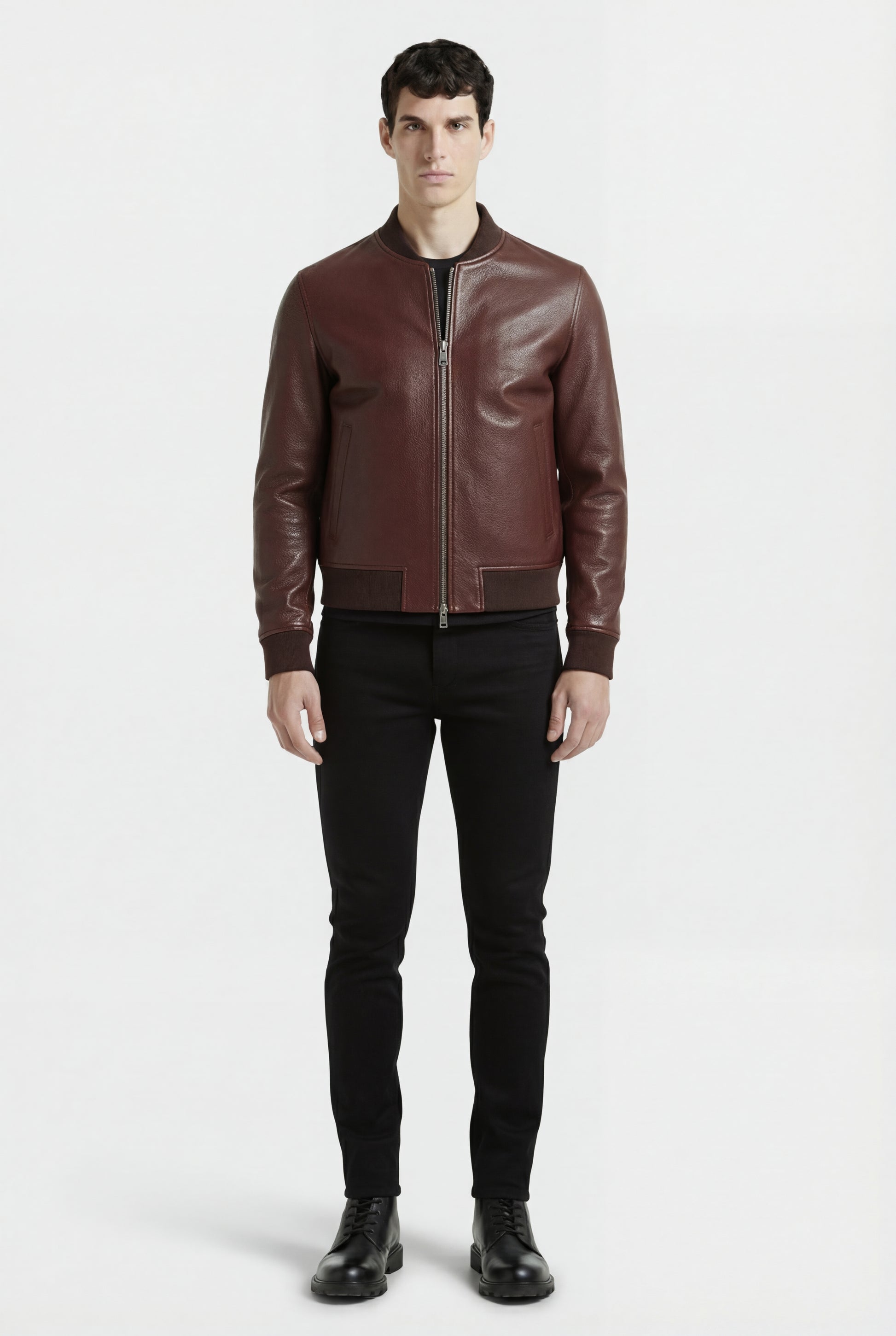 Male model wearing Maverick Ferran leather bomber jacket, regular fit, styled with black crewneck t-shirt and black slim-fit jeans. Maverick Jacket.