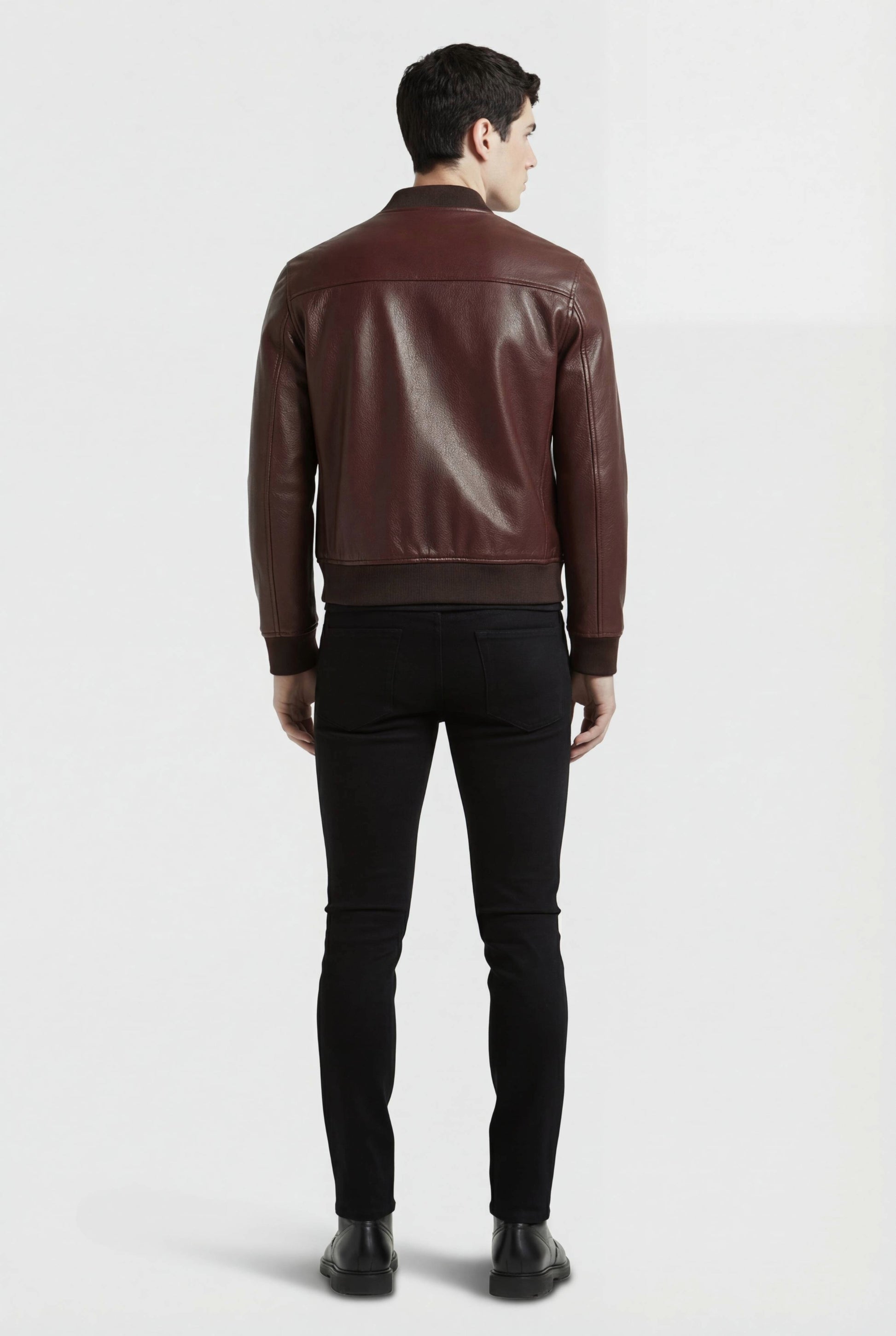 Rear view of male model wearing Maverick Ferran leather bomber jacket showing structured shoulder fit and ribbed hem styling. Maverick Jacket.