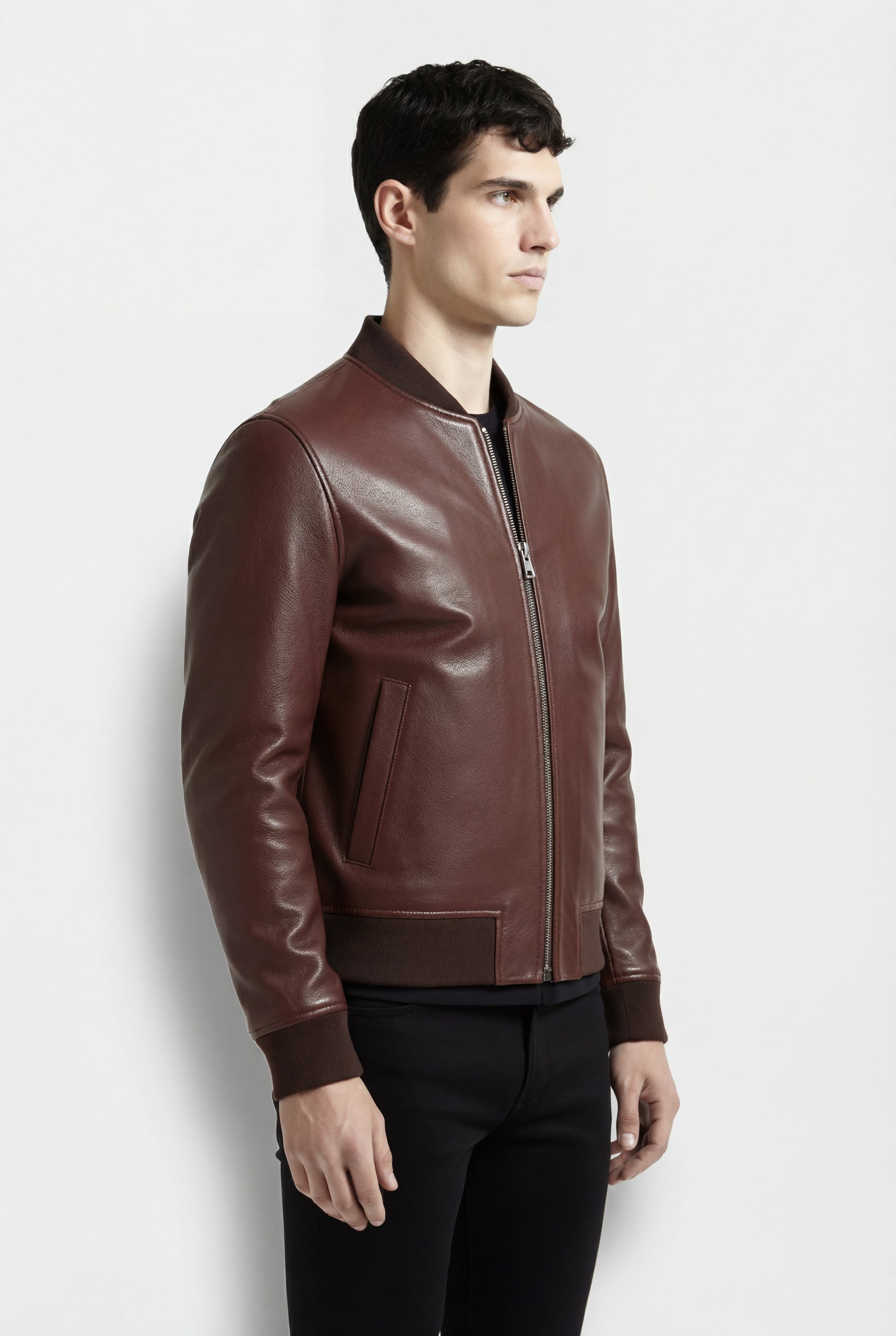 Side profile of Maverick Ferran leather bomber jacket showing ribbed cuff structure and classic bomber silhouette. Maverick Jacket.