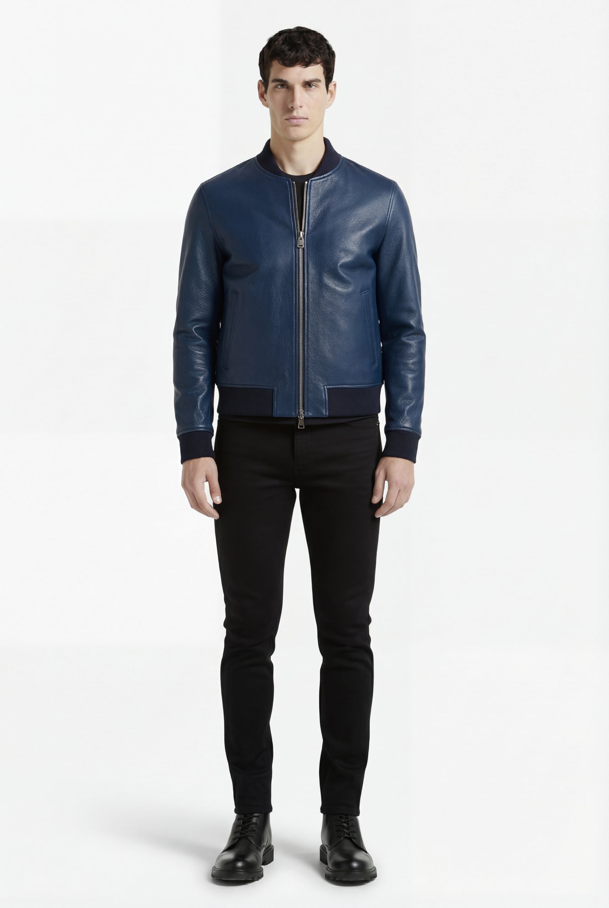 Male model wearing Maverick Solaro leather bomber jacket, slim fit, styled with black skinny jeans and black boots. Maverick Jacket.