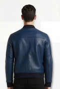 Rear view of male model wearing Maverick Solaro leather bomber jacket showing structured shoulder fit and ribbed hem styling. Maverick Jacket.