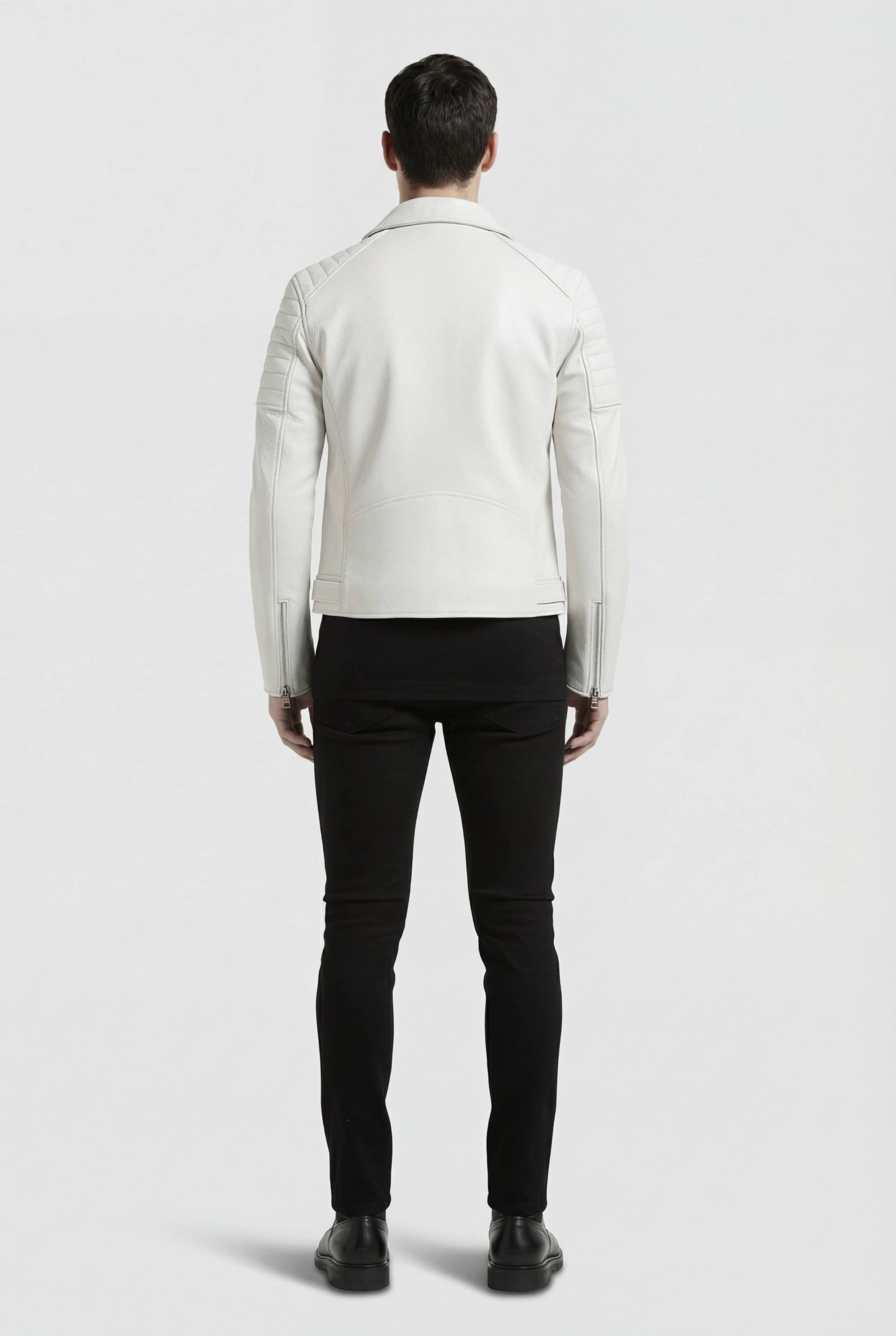 Rear view of male model wearing Maverick Lucent biker jacket showing structured shoulder fit and clean back paneling. Maverick Jacket.