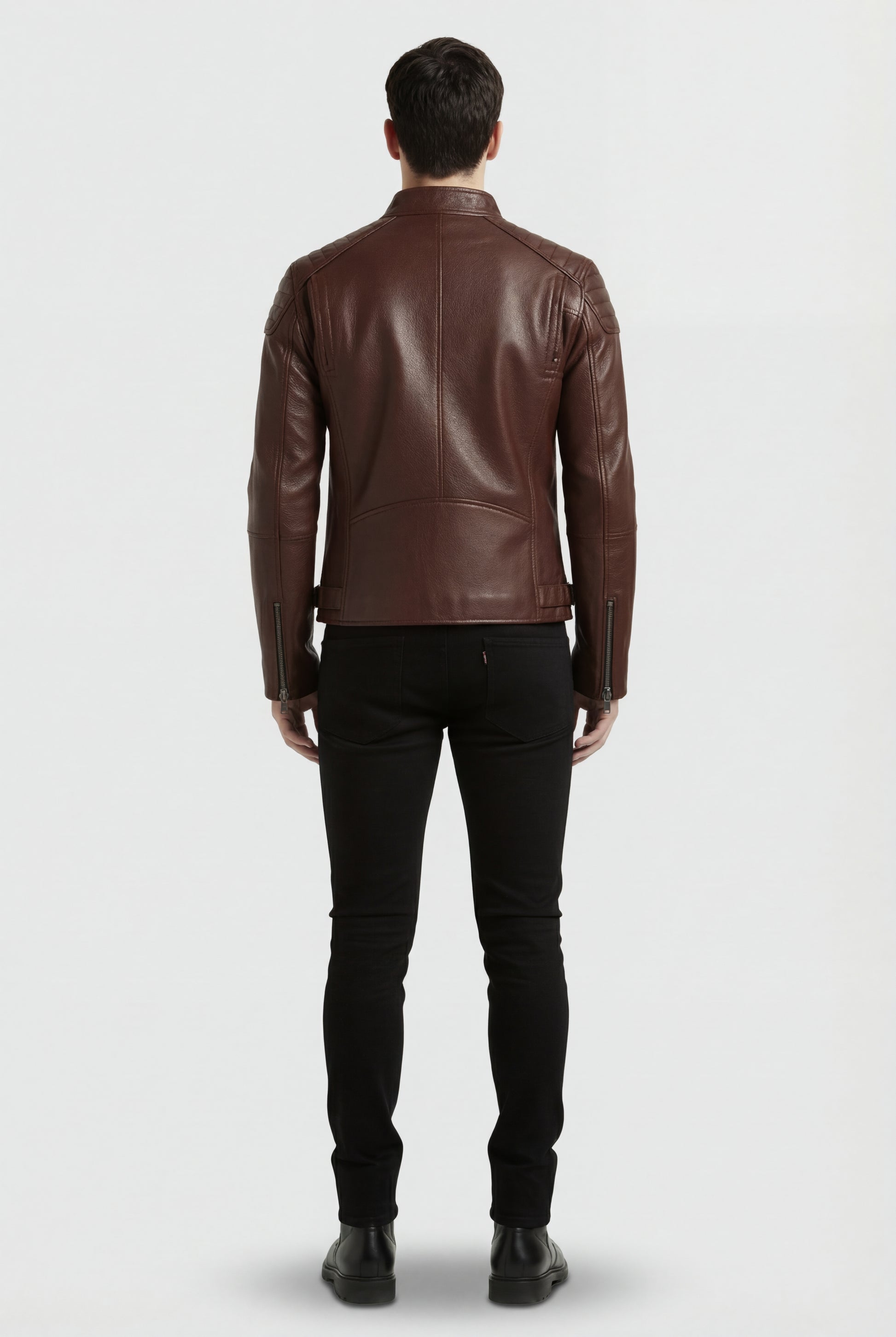 Rear view of male model wearing Maverick Thorne café racer jacket showing structured shoulder fit and quilted paneling. Maverick Jacket.
