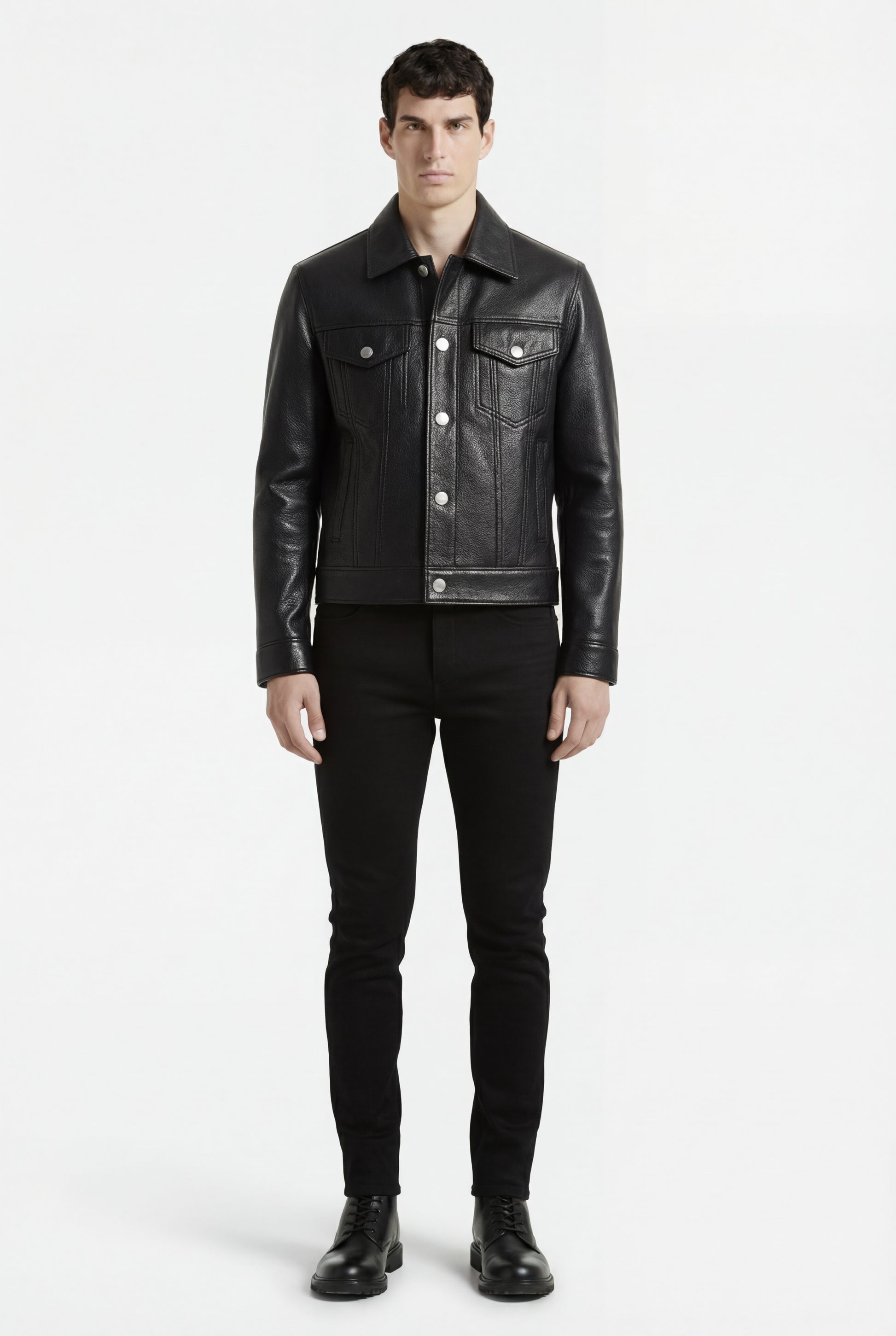 Male model wearing Maverick Veyron leather trucker jacket, slim fit, styled with black slim-fit trousers and black boots. Maverick Jacket.