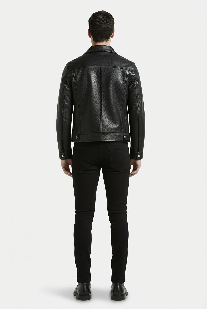 Rear view of male model wearing Maverick Veyron leather trucker jacket showing structured shoulder fit and clean back paneling. Maverick Jacket.