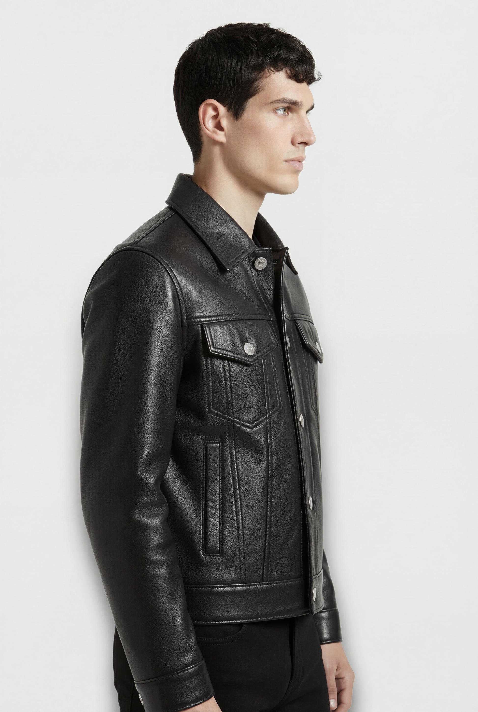 Side profile of Maverick Veyron leather trucker jacket showing set-in sleeve structure and tailored silhouette. Maverick Jacket.