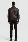 Rear view of male model wearing Maverick Alder leather bomber jacket showing broad shoulder fit and ribbed hem styling. Maverick Jacket.