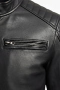 Macro shot of black leather grain texture and dark metal zipper pocket on moto jacket. The Axton by Maverick Jacket.