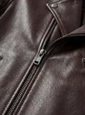Macro shot of brown pebbled leather texture and silver metal zipper hardware on biker jacket. The Roadmaster by Maverick Jacket.