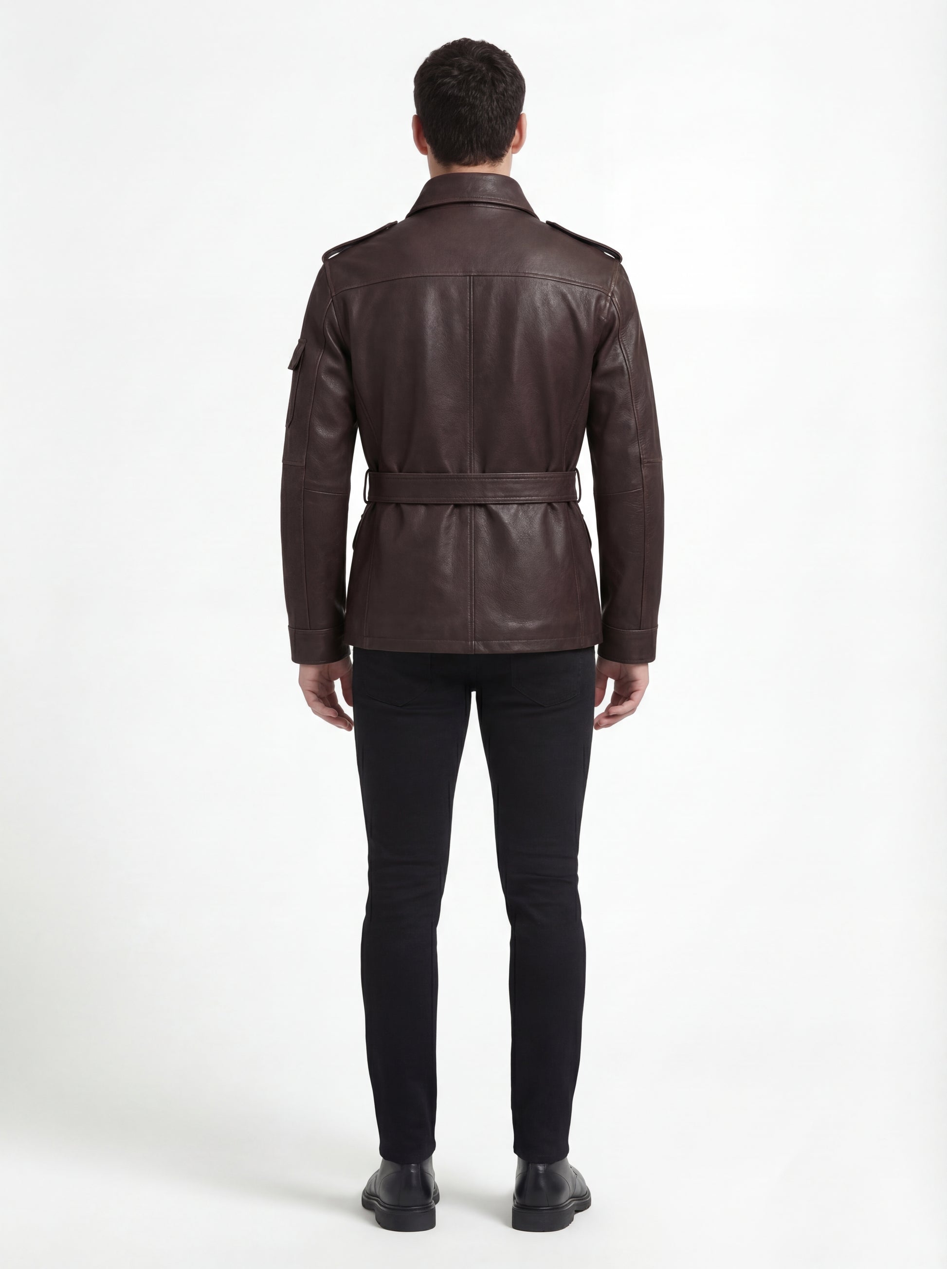 Rear view of male model wearing Maverick Huntsman leather field jacket showing structured shoulder fit and belted waist styling. Maverick Jacket.