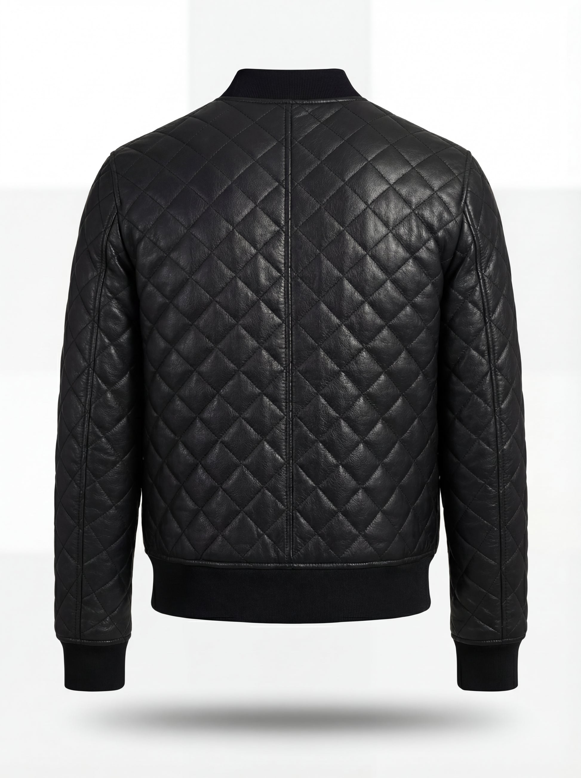 Rear view of black diamond quilted leather bomber jacket showing vertical center seam and ribbed waist hem. The Nero by Maverick Jacket.