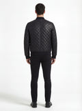 Rear view of male model wearing Maverick Nero quilted bomber jacket showing structured shoulder fit and diamond back paneling. Maverick Jacket.