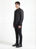 Side profile of Maverick Nero quilted bomber jacket showing diamond quilted sleeve design and slim torso silhouette. Maverick Jacket.